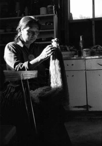Mae Tso, Diné cleans wool from her sheep for rug weaving at her home in Big Mountain on the Navajo Reservation in Arizona, 1986(Navajo)